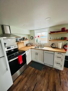 a kitchen with a sink and a stove top oven at State Street Cottage, Suite 1 in Pullman