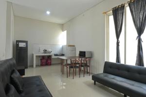 a living room with a couch and a table at GreenLake Vista in Surabaya