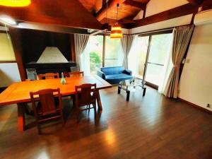 a living room with a table and a blue couch at COCO 湯布院 一棟貸切 ーCOCO Yufuinー in Yufu