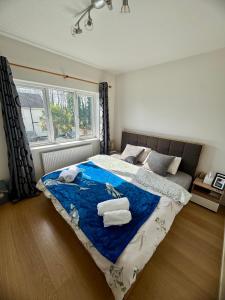 a bedroom with a large bed with towels on it at The Garden Luxe Retreat in Dublin