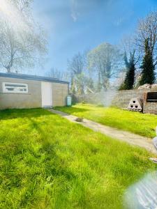 a yard with a house with a sprinklerministic at The Garden Luxe Retreat in Dublin