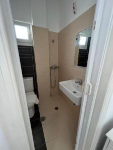 a bathroom with a toilet and a sink at Windmill Rooms in Antiparos Town +16 photos