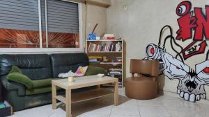 a living room with a green couch and a table at SK Homestay in Casablanca