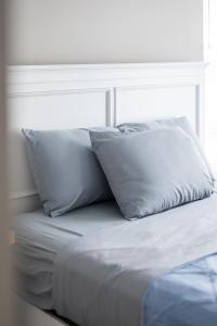 a bed with two pillows on top of it at Luxury Downtown Townhome Private Garage Unit 6 in Cleveland