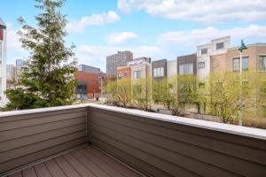 a balcony with trees and buildings in the background at Luxury Downtown Townhome Private Garage Unit 11 in Cleveland