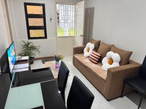 a living room with a couch with stuffed animals on it at Vibrant Vibes Cozy Staycation III in Sorsogon City in Sorsogon