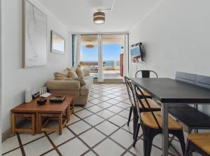 a living room with a table and a couch at Amplia terraza en primera linea, Playa Amarilla in Concón