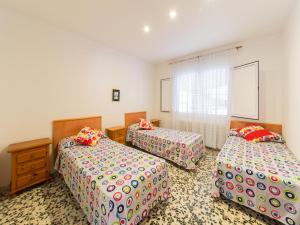 a bedroom with two beds and a window at Villa in L Escala near Riells Beach in L'Escala +14 photos