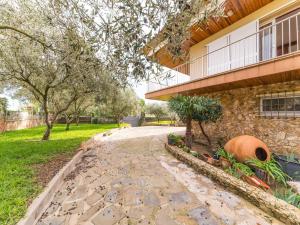 a stone walkway next to a building at Villa in L Escala near Riells Beach in L'Escala