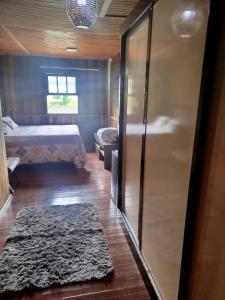 a bedroom with a bed and a sliding glass door at Pousada Bella Montanha in Louro Müller +10 photos