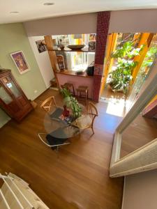 a living room with a glass table and some plants at Jardim Ibirapuera in Sao Paulo
