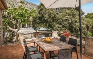 ポリェンサにあるColonya Petitの木製テーブル(果物入り、傘付)