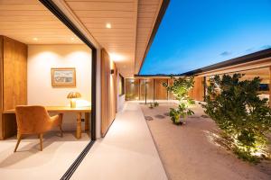 an office with a large window and a desk and chair at Villa Anahere in Haapiti +62 photos
