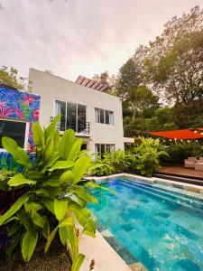 a swimming pool in front of a house at Villa Mary in Punta Leona
