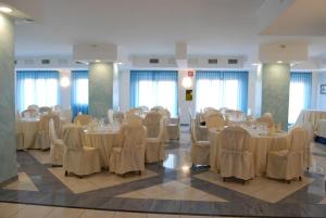 a banquet hall with tables and chairs in a room at Dakar Living Hotel Vasto in Vasto +64 photos
