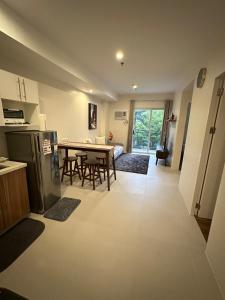 a kitchen and a dining room with a table and a kitchen at Condo in Davao City in Davao City