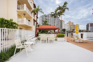 a patio with chairs and tables and a gazebo at The Blue Octopus - 1br King Bed Condo in Fort Lauderdale