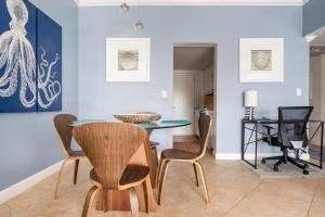 a dining room with a table and chairs at The Blue Octopus - 1br King Bed Condo in Fort Lauderdale