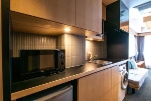 a kitchen with a microwave and a sink at Minn Nijo-jo in Kyoto