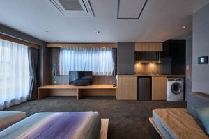 a hotel room with a kitchen and a living room at Minn Nijo-jo in Kyoto