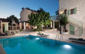 a swimming pool in front of a house at Villa Stanza in Rovinj +54 photos