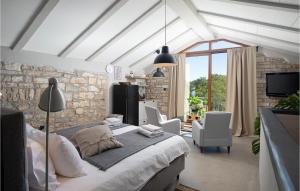 a bedroom with a bed and a stone wall at Villa Stanza in Rovinj