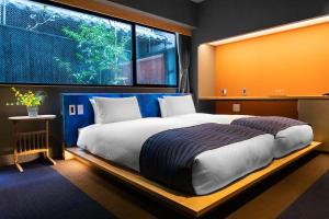 Postel nebo postele na pokoji v ubytování Minn Nijo-jo