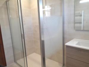 a shower with a glass door next to a sink at Maison charmante près de l'océan à Lit-et-Mixe - FR-1-50-170 in Lit-et-Mixe
