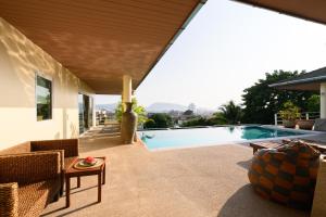 a house with a swimming pool and a patio at Over the Moon villa in Patong Beach
