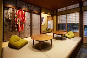 a room with two tables and yellow chairs at Minn Nijo-jo in Kyoto