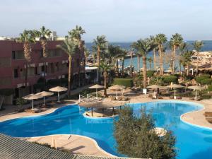 an overhead view of a resort pool with umbrellas at Apartment sea view in Hurghada