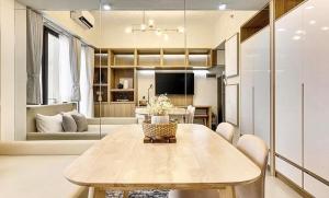 a dining room with a table and a living room at New Condo at Cebu City in Cebu City