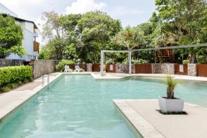 a swimming pool with blue water in a yard at Reflections on the lake with resort access in Twin Waters