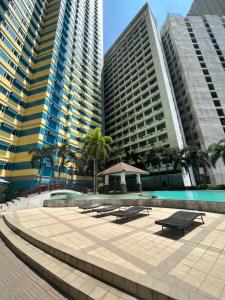 a group of picnic tables in front of tall buildings at The Grand Towers Manila in Manila