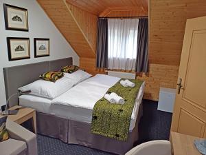Postel nebo postele na pokoji v ubytování Hotel a vinařství Sádek