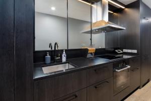 una cocina con fregadero y estufa en Stunning 1BR Apartment with Water Views, en Kingston  4 fotos más