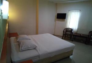 Postel nebo postele na pokoji v ubytování Puri Dibia Hotel by Secoms