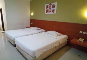 Postel nebo postele na pokoji v ubytování Puri Dibia Hotel by Secoms