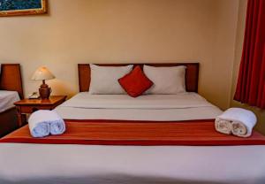 Postel nebo postele na pokoji v ubytování Puri Dibia Hotel by Secoms