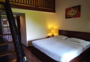 Postel nebo postele na pokoji v ubytování Puri Dibia Hotel by Secoms