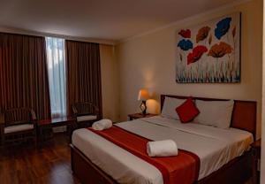 Postel nebo postele na pokoji v ubytování Puri Dibia Hotel by Secoms