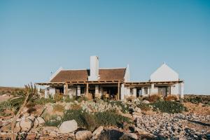 a house sitting on top of a rocky hill at DagDromer Holiday Home in Jacobs Bay