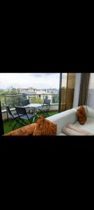 a white couch with pillows and a table and chairs at Sasha BnBs in Nairobi