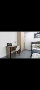 a bedroom with a bed and a desk and a chair at Sasha BnBs in Nairobi +29 photos