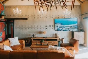 a living room with a couch and a table at DagDromer Holiday Home in Jacobs Bay