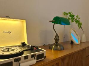 a desk with a lamp and a clock on it at OnMeSTAY in Suwon