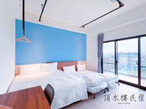 Postel nebo postele na pokoji v ubytování Aqua rooftop 頂水樓玩趣民宿