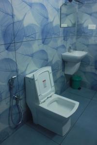 a bathroom with a toilet and a sink at Ferns n' Falls in Chinnakanal