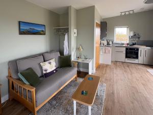 a living room with a couch and a table at The Wheelhouse in Carinish