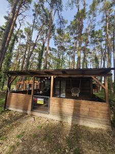 a cabin in the woods with a screened in porch at Domek letniskowy nr 16 - jezioro Głębokie in Międzyrzecz +3 photos